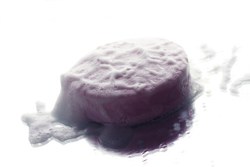Purple soap and bubbles on a white background