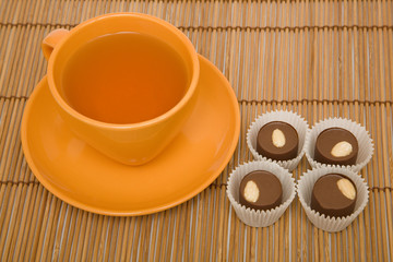 Cup of tea and four chocolate sweets