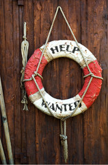 A worn life saver with the caption Help Wanted