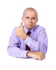 Smiling businessman showing thumb up