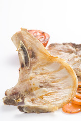 tasty pork chop with corn carrot tomato