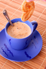 Cup of coffee with milk and cookies isolated over white backgrou