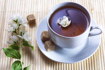 Fresh cup of tea with beautiful jasmin flower