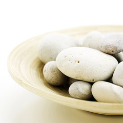 Fototapeta na wymiar pebbles in bamboo bowl