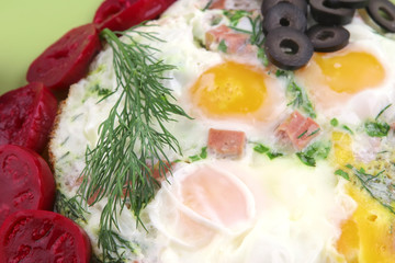 fried eggs and red eggplant