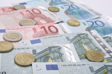 Euro coins with euro banknotes, financial background