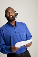 Businessman with phone headset and document