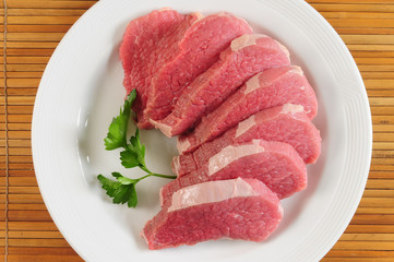 Red meat on white plate