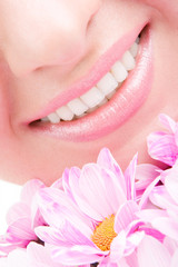 Smile of young woman with flowers
