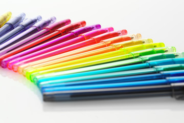 Isolated colourful pens in a curve