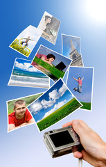 Digital camera and photographs against blue background