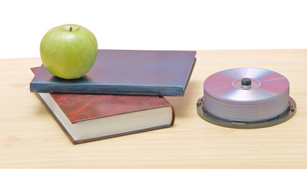 Apple, dvd, and books as a symbol of transition fron old to new