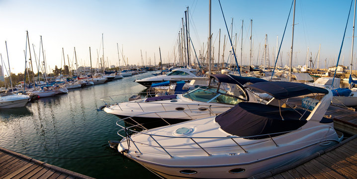 series of panoramic images from the harbor with yachts at dusk