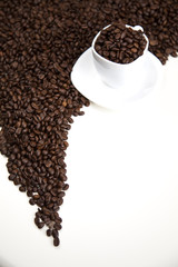 Cup with beans coffee on white