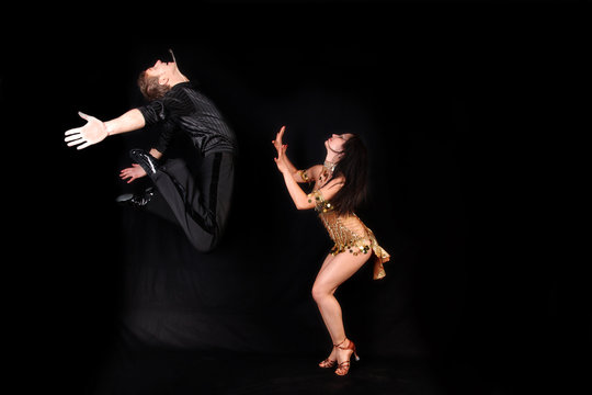 dancers against black background