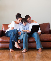 Parents and son playing with a laptop