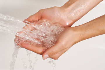 Hands under a stream of shower