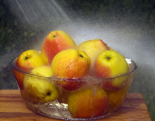 Apples in a bowl and rain drops