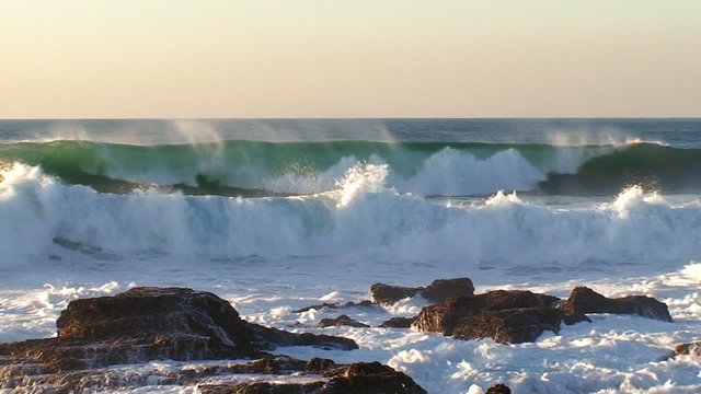 Big waves against rock in the beach