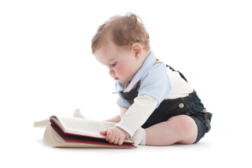 Two years old cute boy reading a book