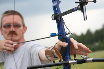 man  shooting to archery target.