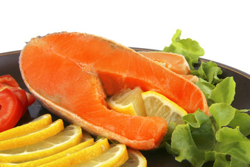 two salmon steak on dark dish