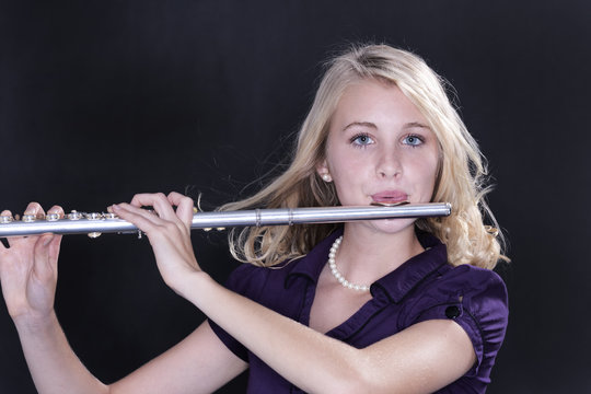 Teenage Girl Flute Player On Black