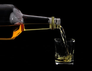 Scotch pouring into glass