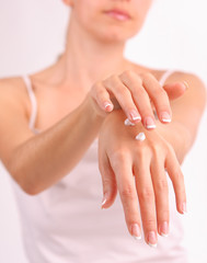 Woman puts a cream for beautiful hands