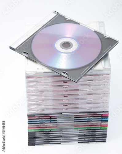 A Blank Dvd Or Cd With Stack Of Empty Cd Cases On Background Stock