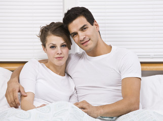 Fototapeta premium Attractive couple in bed together