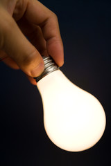 Hand holding a Bright Light Bulb