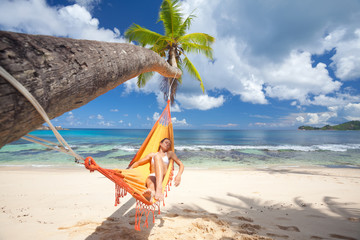 woman relaxing in orange hammock