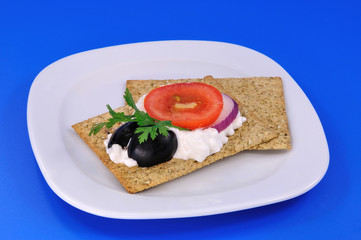 cracker with cheese and olives