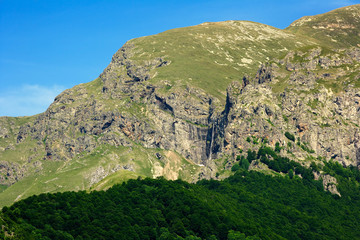 Rocky mountain peak with waterfall