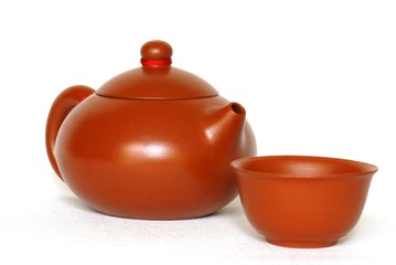 Chinese teapot and teacup against white background