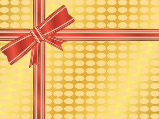 Red and gold ribbon and bow on a gold wrapped gift