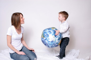 mother and son playing with a globe