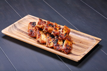 Grilled pork ribs on wooden plate