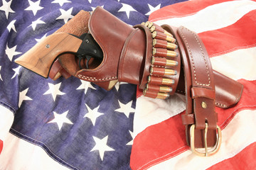 Pistol in holster on American flag