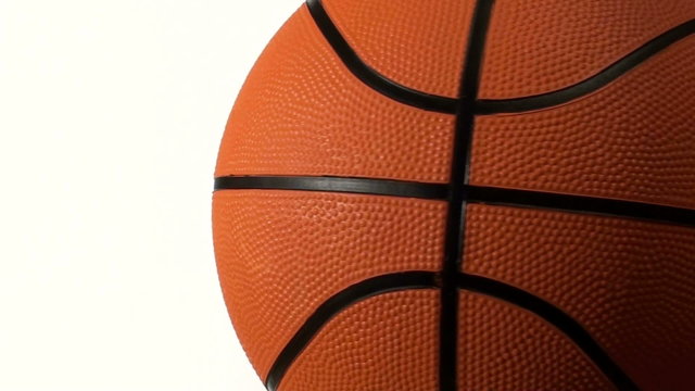 Basketball rotates against white with copy space - HD