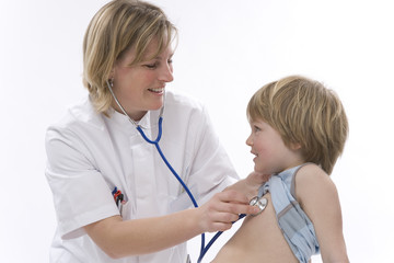 Female doctor is listening to the heartbeat of a little boy