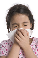 Little girl blowing her nose