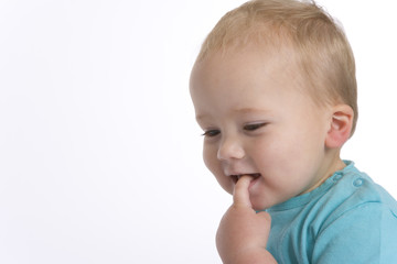 Portrait of a cool toddler boy with a finger in his mouth