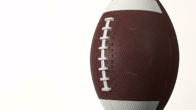 Football spins against white with copy space- HD