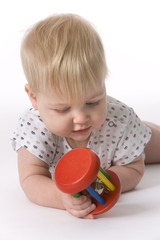 Toddler girl is playing with a colored toy