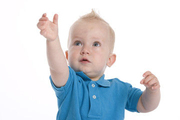 Toddler boy is reaching out his hand