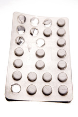 Pills in blister pack over white background
