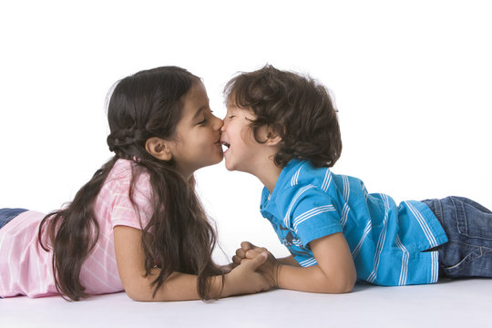 Brother & sister kissing each other