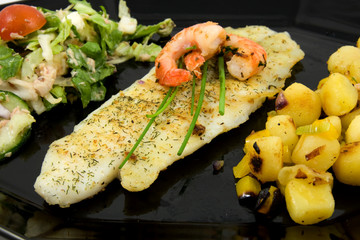 Plate with fish, potatoes and lettuce